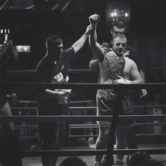 Courtney in the ring with his arm raised