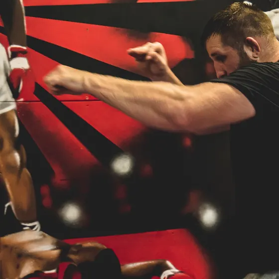 Courtney with his guard up, shadowboxing in front of the gym murals