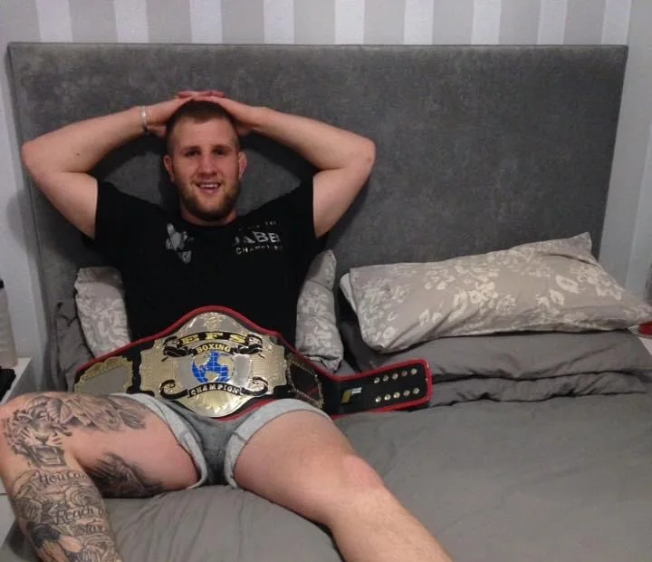 Courtney Richards smiling, hands behind his head