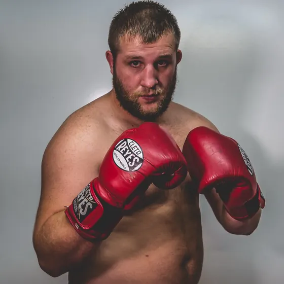 Portrait of Courtney in red boxing gloves, guard up