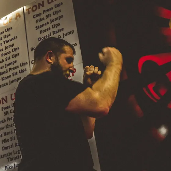 Courtney shadowboxing in front of the gym murals
