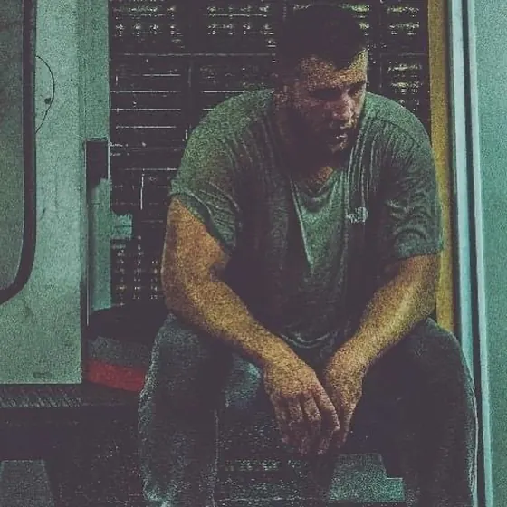 Courtney sitting in the gym, resting after training