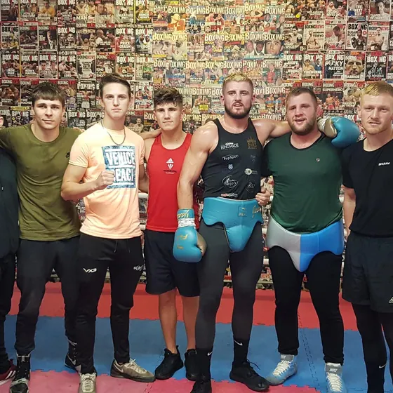Courtney with a line-up of boxers in the gym