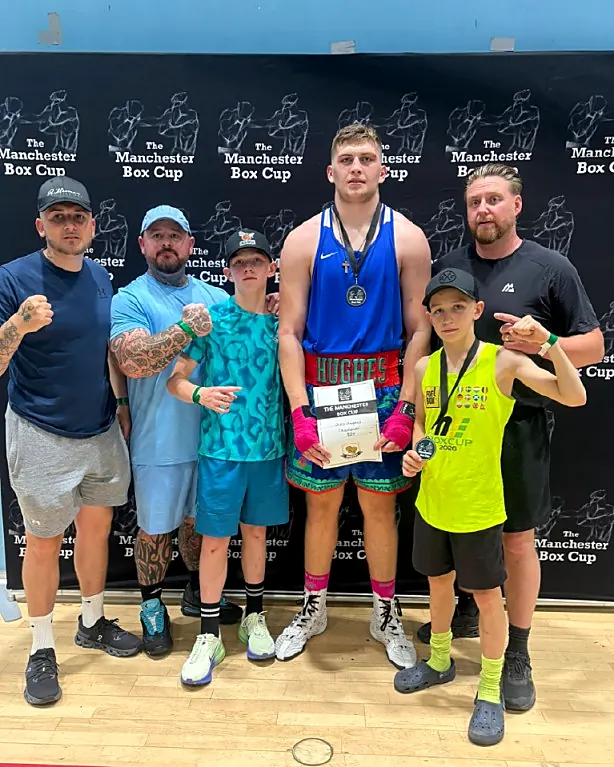 Young boxers with coaches celebrating at Intense Boxing Plymouth